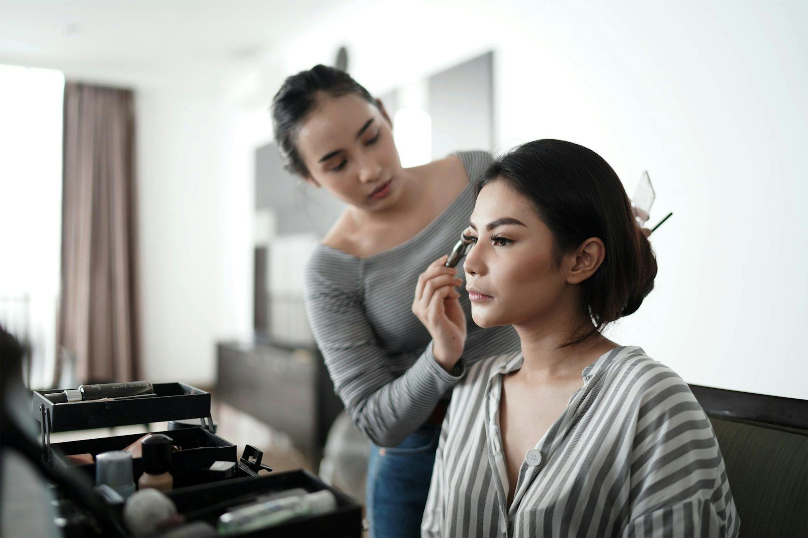 Celine applying makeup to a client