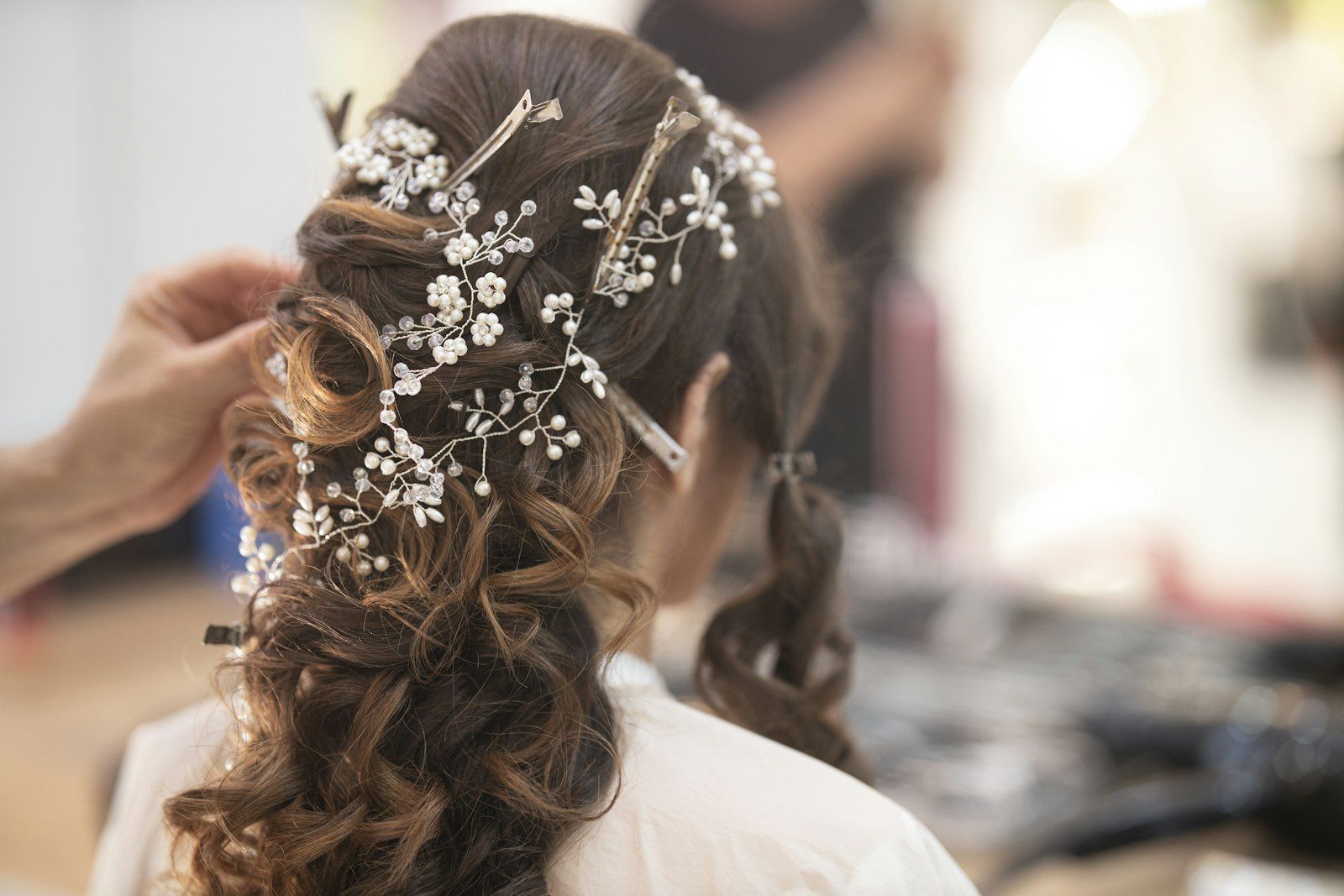 Pearl hair pieces placed in soft curls